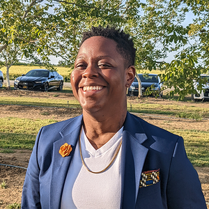 Jane Mantey smiling outdoors in a suit jacket