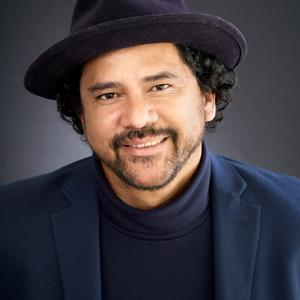 Latino male with mustache wearing black hat and black shirt