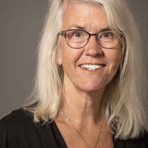 Headshot photo of Julie Nelson; middle-aged Caucasian woman with shoulder-length hair