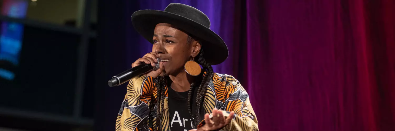 Person speaking into microphone.